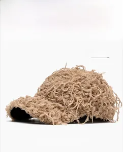 Detailed close-up of khaki plush baseball cap featuring long faux fur texture and shaggy style