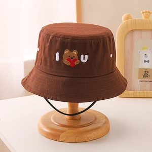Close-up of brown kids bucket hat with bear embroidery and black windproof lanyard