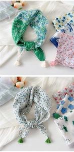 Detail of printed cotton linen scarf featuring colorful patterns and delicate fringe tassels