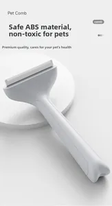 Close-up of ergonomic pet deshedding brush with ABS handle and fine metal teeth