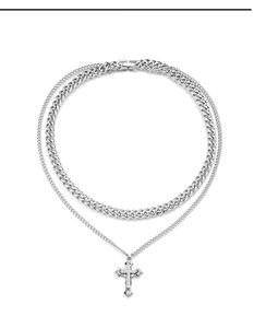 Close-up of double-layered silver cross pendant necklace with sparkling cubic zirconia