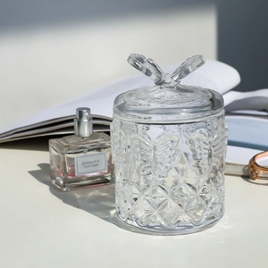 Elegant clear embossed glass storage jar with butterfly handle for jewelry and home decor