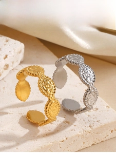 Detailed view of gold and silver vintage geometric oval textured adjustable rings