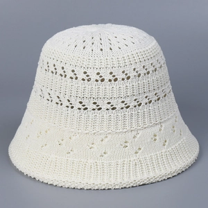 Detailed close-up of breathable hollow-out crochet texture on a beige knit bucket hat