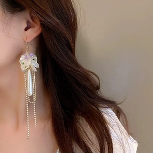 Floral pearl tassel earrings with purple resin flowers and green rhinestones