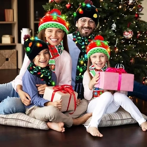 Family wearing festive LED Christmas knitted beanies and matching scarves with reindeer patterns