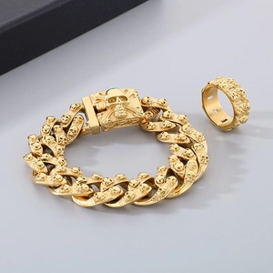 Detailed close-up of golden stainless steel skull Cuban bracelet and matching ring