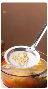 Close-up of encrypted fine mesh stainless steel skimmer spoon filtering soup foam