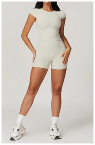 Close-up of high-waist yoga shorts and short-sleeved top in seamless matte fabric