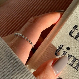 Close-up of minimalist 925 sterling silver beaded ring worn on index finger