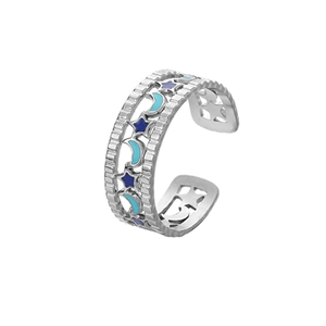 Detailed macro view of open ring featuring star moon cutouts with blue enamel inlay