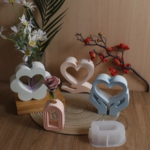 DIY silicone molds for heart and flower resin vases on a rustic wooden background