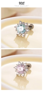 Macro detail of snowflake earrings with light blue and pink stones in titanium steel