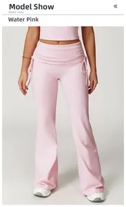 Detail of peach pink high waisted flared yoga pants with adjustable side drawstrings