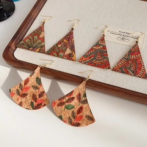 Detailed view of three pairs of cork boho earrings with vintage floral patterns