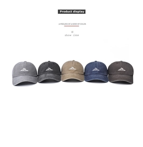 Row of five washed cotton baseball caps with mountain embroidery in multiple colors