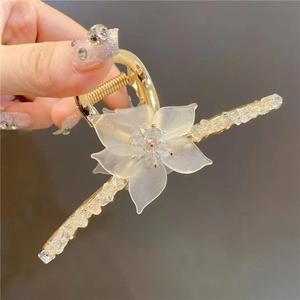 Elegant gold metal hair claw with frosted flower and sparkling crystal rhinestones