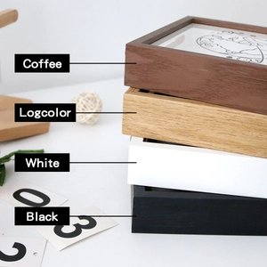Detail of four colored wooden ticket memory boxes in coffee, log, white, and black finishes