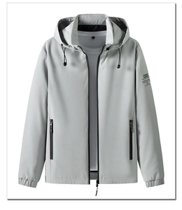 Detail of light gray hooded windbreaker with zippered pockets and sleeve logo