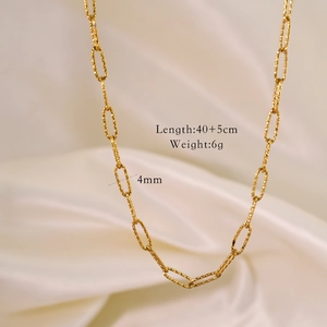 Detailed close-up of 14k gold plated textured oval link chain necklace on white silk