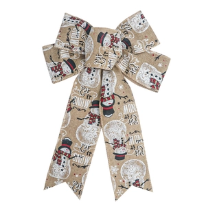 Rustic Christmas bow with snowflake and elk patterns on burlap fabric for holiday decor
