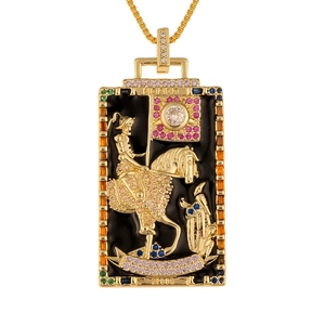 Detail of gold tarot Death pendant with colorful gemstones and black enamel finish