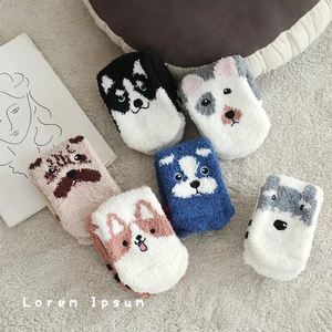 Set of six colorful coral fleece socks featuring cute cartoon dog patterns on beige rug