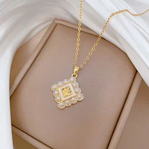Macro view of gold cross pendant with pearls and diamonds on a soft silk background