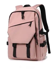 Detail view of pink water-resistant nylon backpack showing front pocket and side pocket