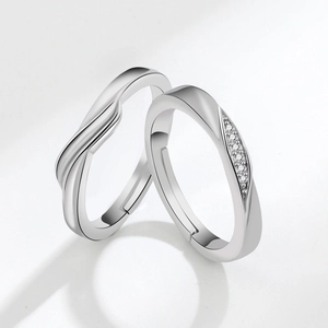 Adjustable silver couple rings featuring Mobius twist design and sparkling zircon pavé