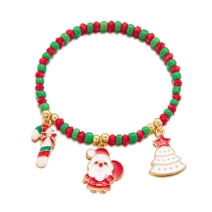 Detailed macro of Christmas bead bracelet with Santa, tree and candy cane charms