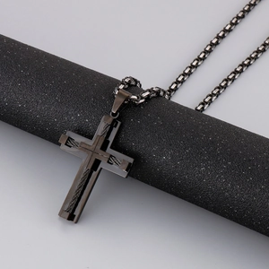 Macro shot of double-layer black stainless steel cross pendant on robust box chain