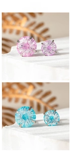 Detail von rosa und blauen Zirkon-Ohrsteckern mit Feuerwerksschliff und Vier-Klauen-Fassung
