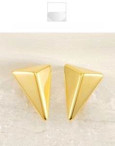 Detailed close-up of 18K gold triangle earrings with a polished 3D geometric finish