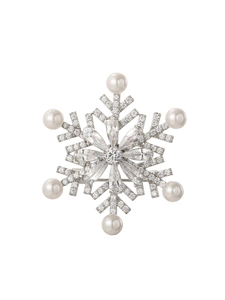 Macro detail of snowflake brooch with sparkling marquise crystals and white pearls