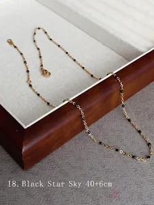 Detail of 18k gold plated titanium necklace with black gypsophila beads and lobster clasp