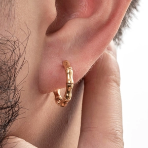 Vintage gold bamboo textured stainless steel hoop earrings shown worn on the ear
