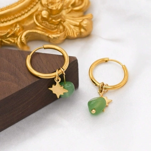Detail of gold hoop earrings featuring star charms and green amazonite stone beads
