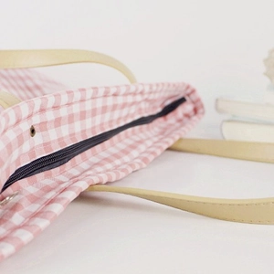 Pink plaid canvas tote bag with zipper closure and beige shoulder strap in casual style