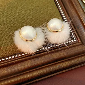 Retro faux pearl and pink fur ball earrings for women featuring gold-tone metallic edges