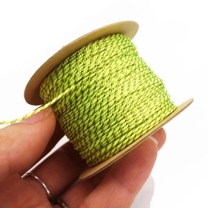 Close-up of 1mm neon green and gold thread for DIY jewelry making and tassels