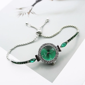 Women's silver quartz watch with a green dial and adjustable rhinestone chain bracelet