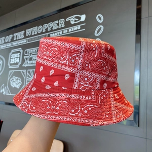 Detail view of red paisley bucket hat featuring intricate white patterns and high-quality fabric
