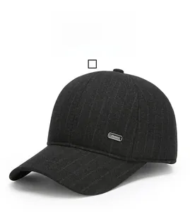 Detail of black wool baseball cap featuring a silver Fashion metal tag and striped texture