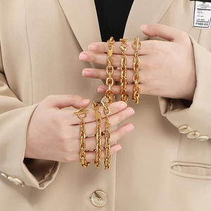 Detail shot of chunky gold stainless steel O-chains with toggle clasp on model