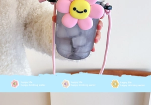 Detail of purple sunflower straw cup with pink woven strap and cute floral charm