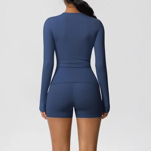 Detail view of the back of a navy blue brushed yoga set with long sleeve top and shorts