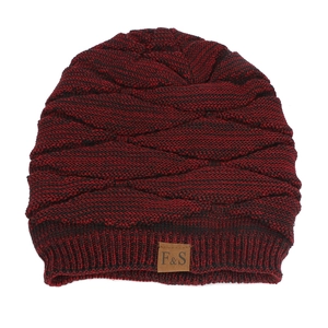Close-up of red and black knit hat with 3D diamond texture and leather logo tag