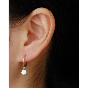 Close-up of S925 sterling silver octagonal hoop earring with a sparkling star charm