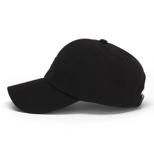Close-up of black baseball cap showing the detailed embroidery and six-panel stitching